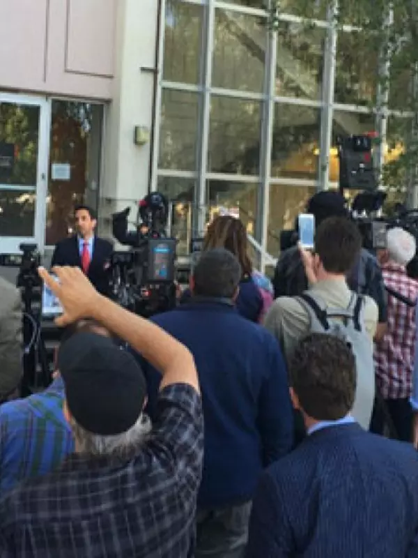 Santa Clara County District Attorney, Jeff Rosen, holding a press conference outside a building