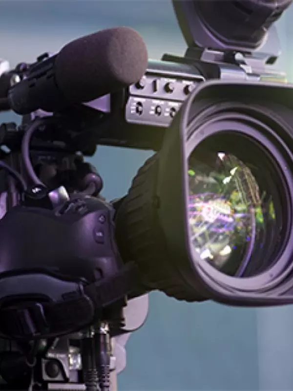 A close-up of a broadcast video camera