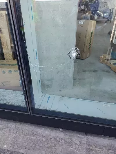 Image of a window vandalized by what is believed to be a slingshot. 